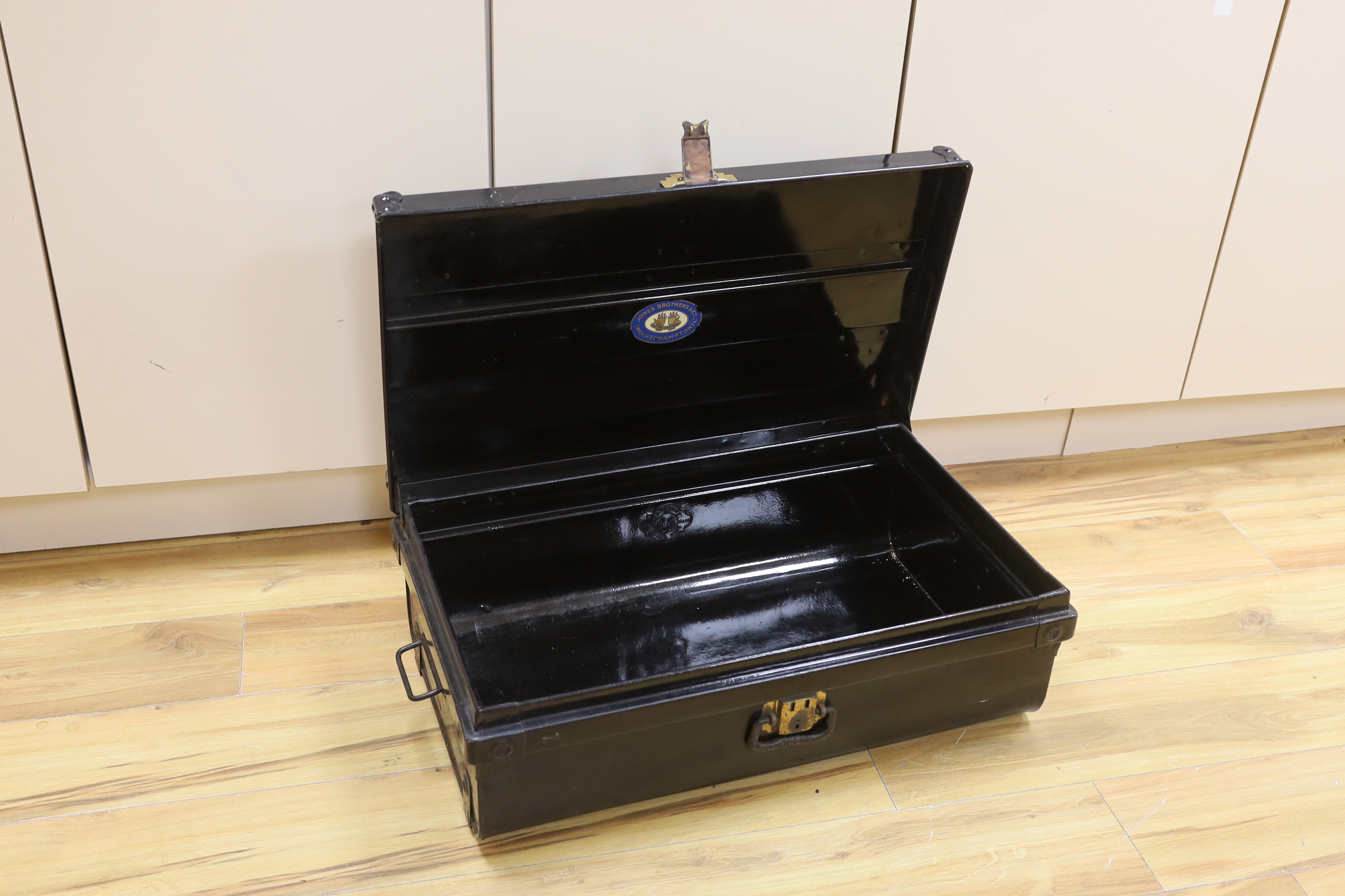 A black lacquered tin trunk, 68cm wide